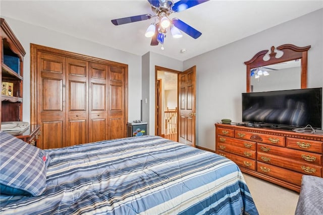 carpeted bedroom with ceiling fan and a closet