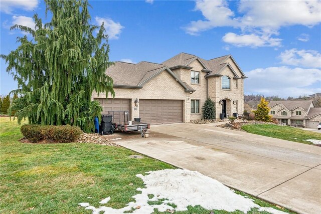 view of front of home with a garage and a front yard