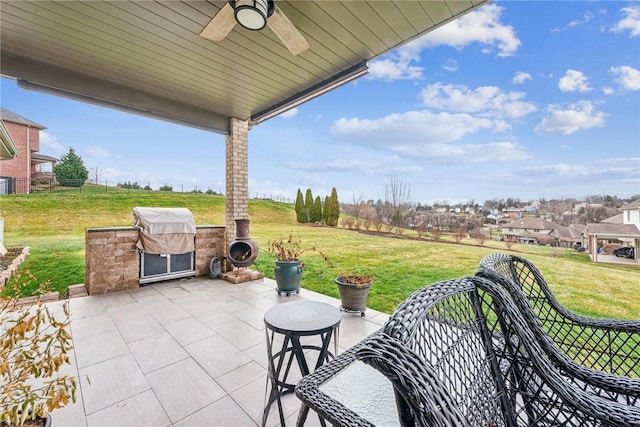 view of patio featuring area for grilling, ceiling fan, and an outdoor kitchen