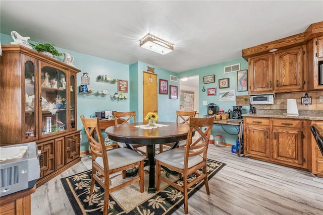 dining area with light wood-type flooring