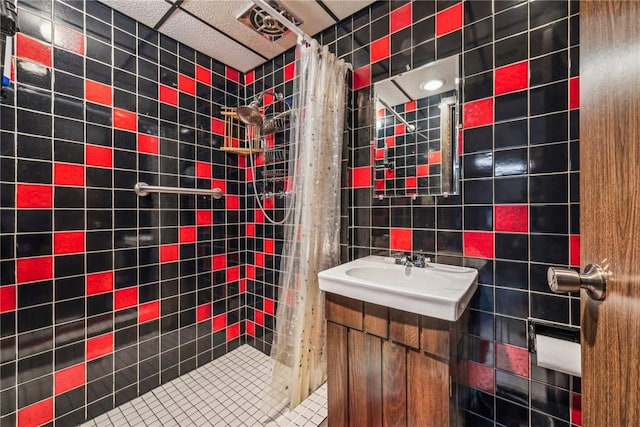 bathroom featuring vanity, tile walls, and walk in shower