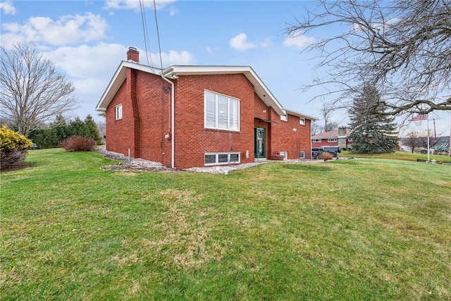 rear view of house featuring a yard