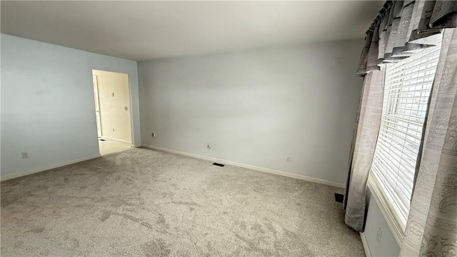 empty room featuring light colored carpet