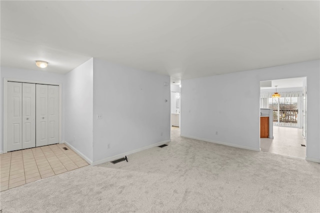 unfurnished room featuring light colored carpet