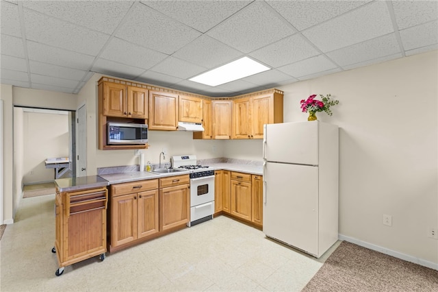 kitchen with sink, a paneled ceiling, and white appliances