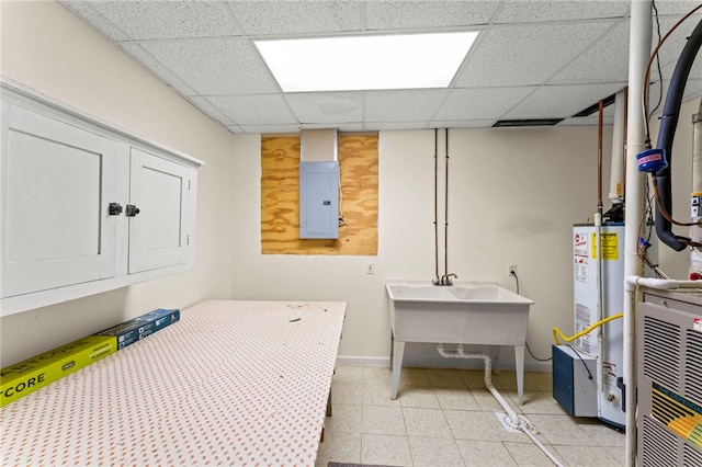 laundry room featuring water heater, sink, and electric panel