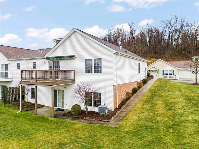 back of property with central AC, a yard, a deck, and a patio area