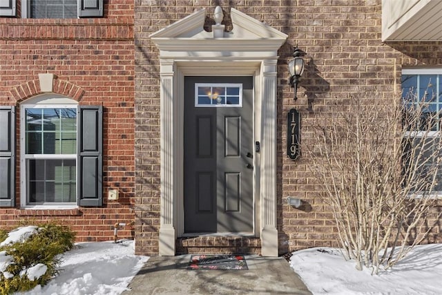 view of snow covered property entrance