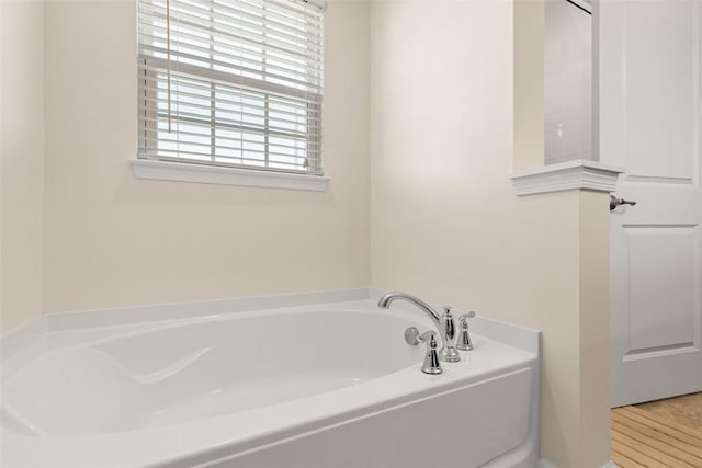 bathroom with a tub to relax in