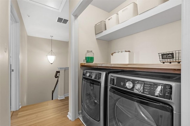 washroom featuring independent washer and dryer and light hardwood / wood-style floors