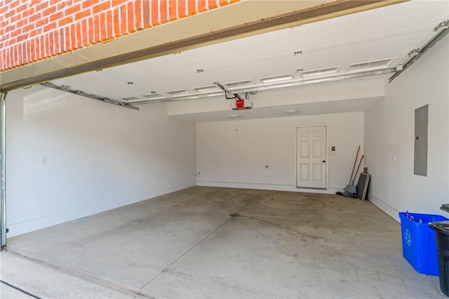 garage with a garage door opener and electric panel