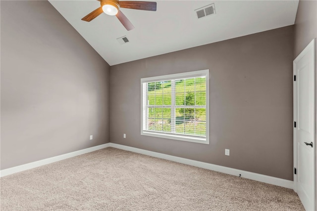 carpeted empty room with vaulted ceiling and ceiling fan