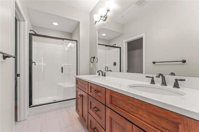 bathroom featuring vanity, tile patterned floors, and a shower with door