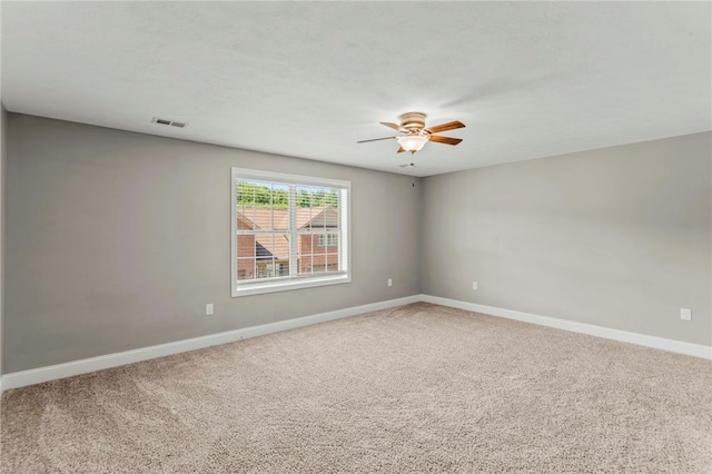 carpeted empty room featuring ceiling fan