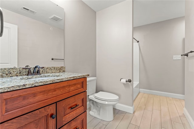 full bathroom featuring hardwood / wood-style flooring, vanity, toilet, and shower / washtub combination