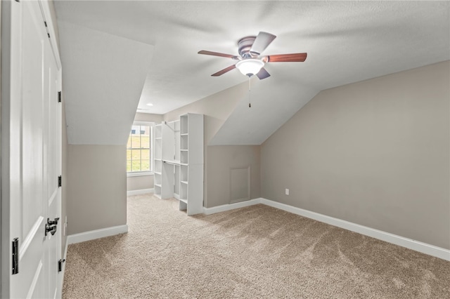 bonus room featuring light carpet, lofted ceiling, and ceiling fan