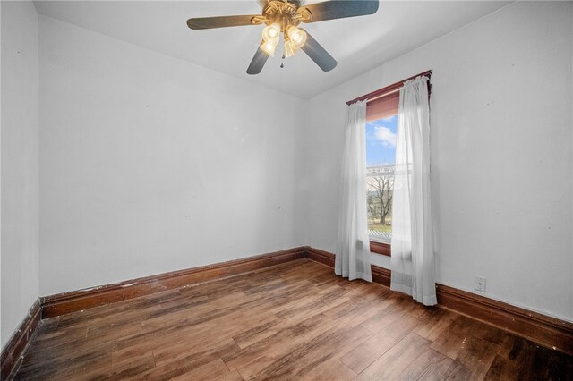 empty room featuring wood-type flooring and ceiling fan