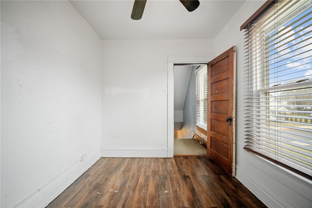 unfurnished bedroom featuring ceiling fan and dark hardwood / wood-style flooring