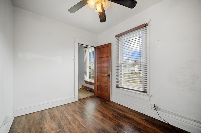 empty room featuring dark hardwood / wood-style flooring and ceiling fan