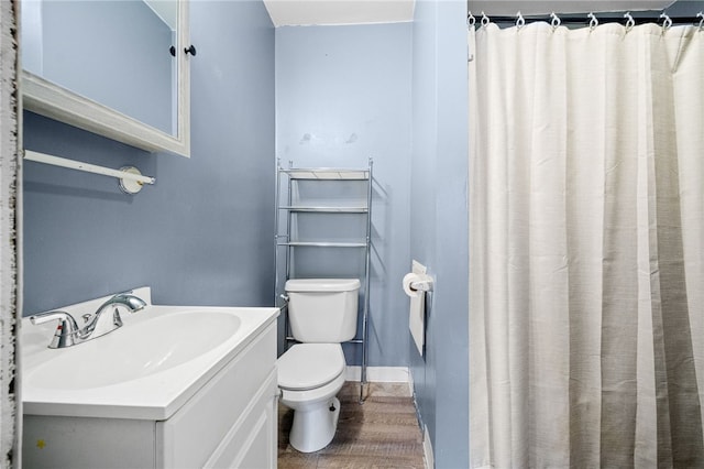 bathroom with a shower with curtain, wood-type flooring, toilet, and vanity