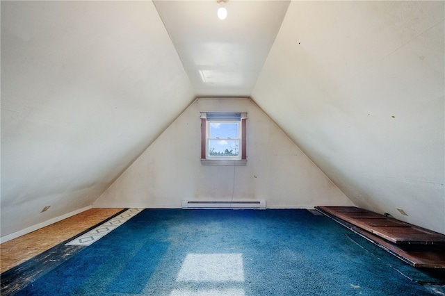 additional living space featuring a baseboard radiator, vaulted ceiling, and carpet