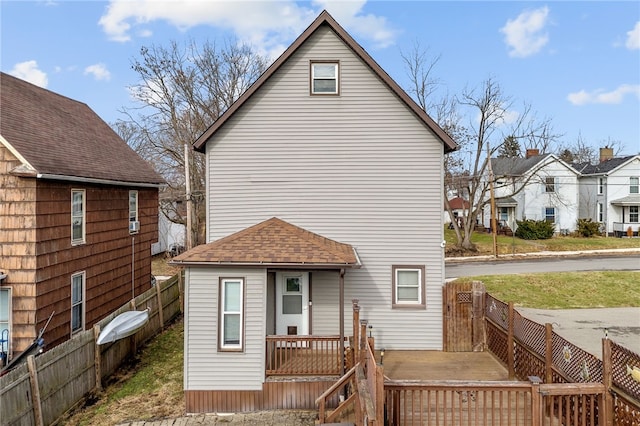 back of house featuring a deck