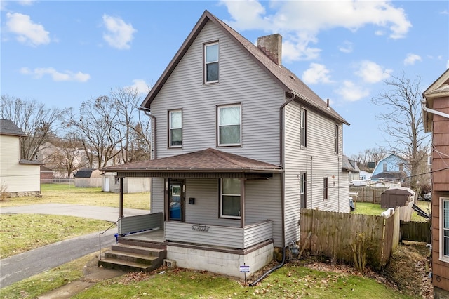 view of front facade with a front yard and a porch