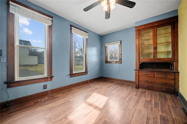 spare room featuring hardwood / wood-style flooring and ceiling fan