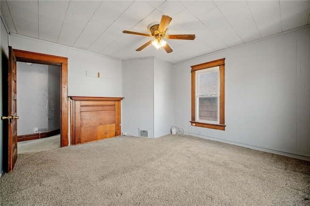 carpeted spare room with ceiling fan