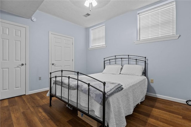 bedroom with dark wood-type flooring and ceiling fan