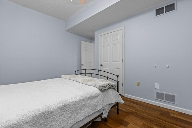 bedroom with dark hardwood / wood-style flooring and ceiling fan