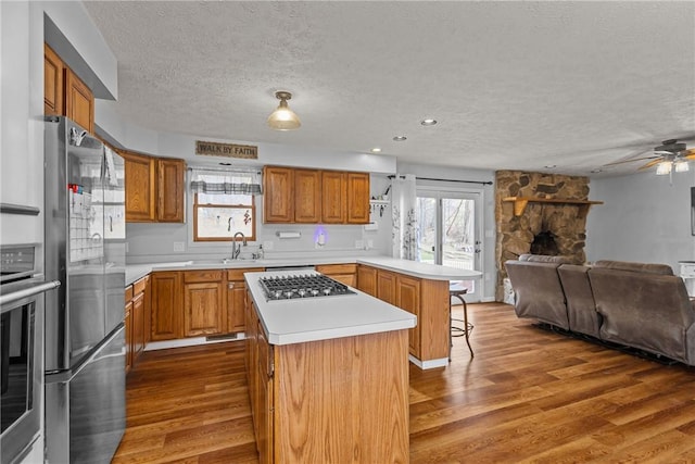 kitchen featuring a breakfast bar, stainless steel appliances, dark hardwood / wood-style floors, and a center island