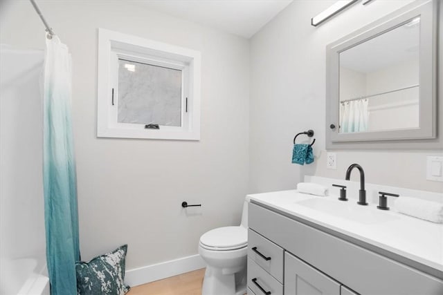 full bathroom with vanity, wood-type flooring, shower / bathtub combination with curtain, and toilet