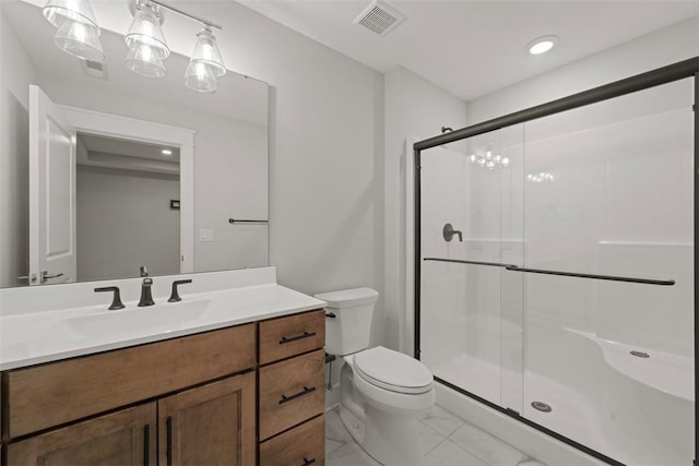 bathroom featuring vanity, an enclosed shower, and toilet