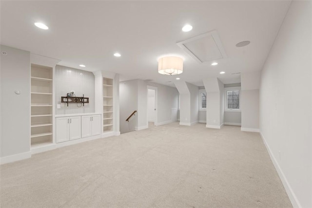 basement with light colored carpet and built in features