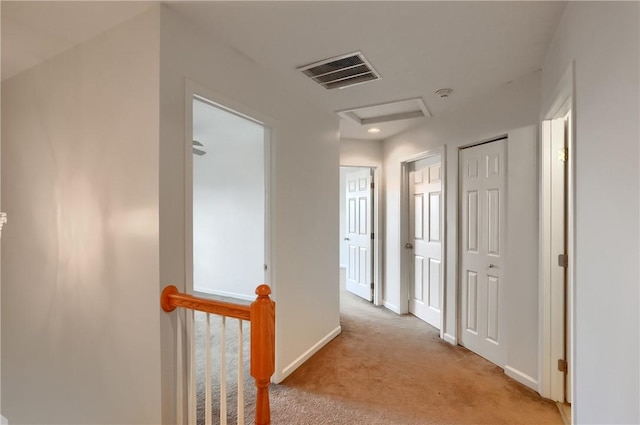 hallway featuring light carpet