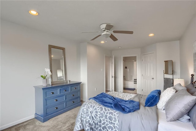 carpeted bedroom with connected bathroom and ceiling fan