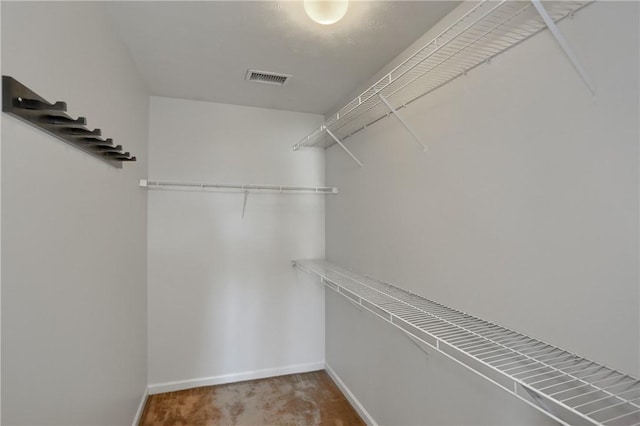 walk in closet with carpet flooring