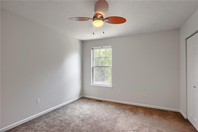 spare room with carpet and ceiling fan