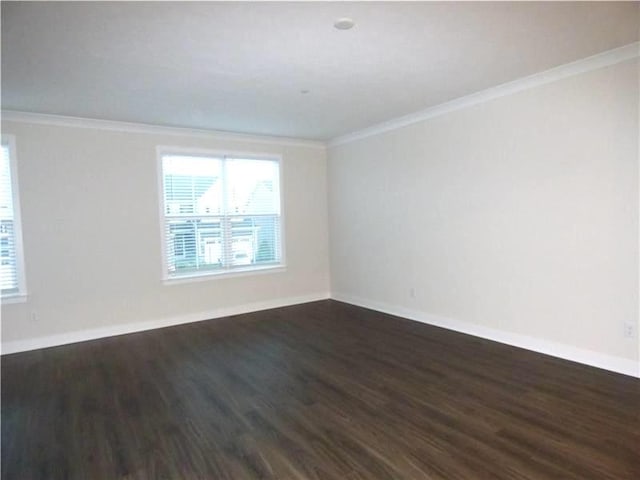 spare room with crown molding and dark hardwood / wood-style floors