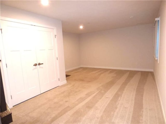 interior space featuring light colored carpet and a closet