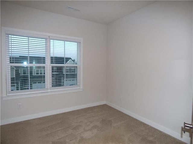 empty room featuring light colored carpet