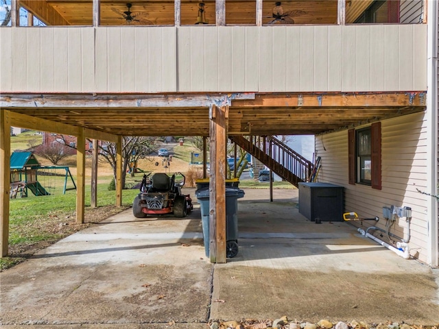 view of patio with a carport, ceiling fan, and a playground