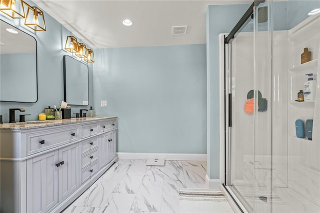 bathroom with vanity and a shower with shower door