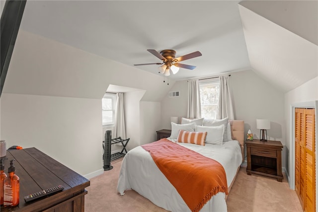 bedroom with multiple windows, light carpet, lofted ceiling, and ceiling fan