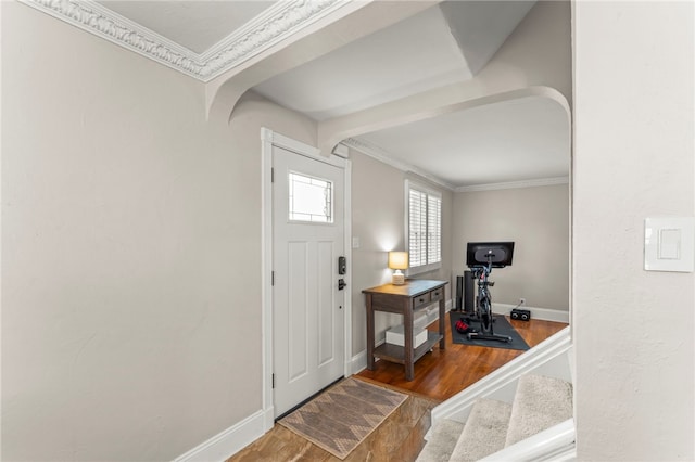 entrance foyer featuring wood-type flooring and crown molding