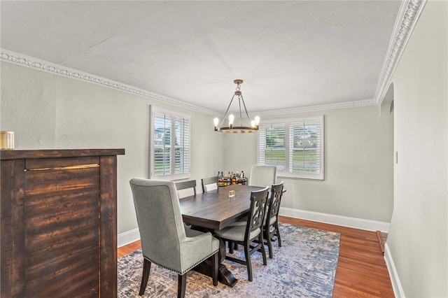 dining space with hardwood / wood-style flooring, crown molding, and plenty of natural light