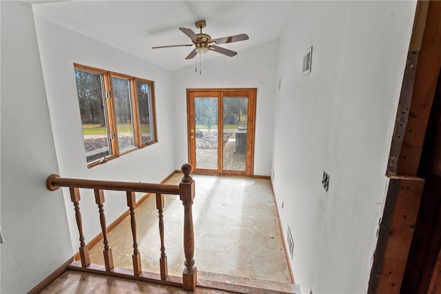 interior space with ceiling fan and vaulted ceiling