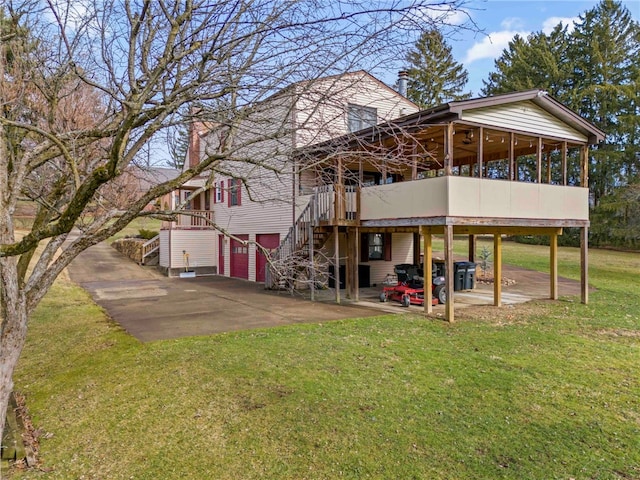 back of house with a sunroom, a yard, and a patio