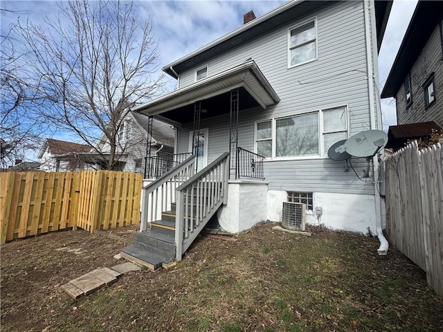 back of house featuring central AC unit